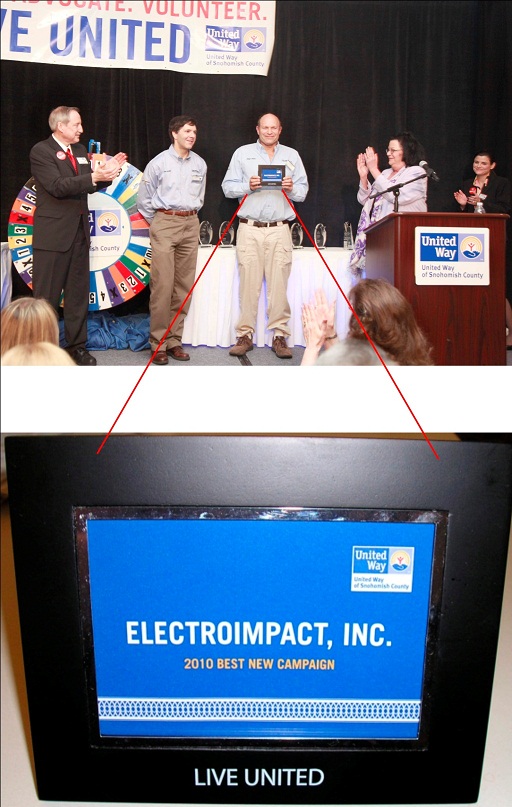 Peter Zieve (center), President of Electroimpact is presented with the award